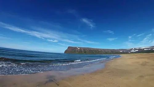 Plage sur la baie d'Adalvik en Islande avec vue sur les falaises