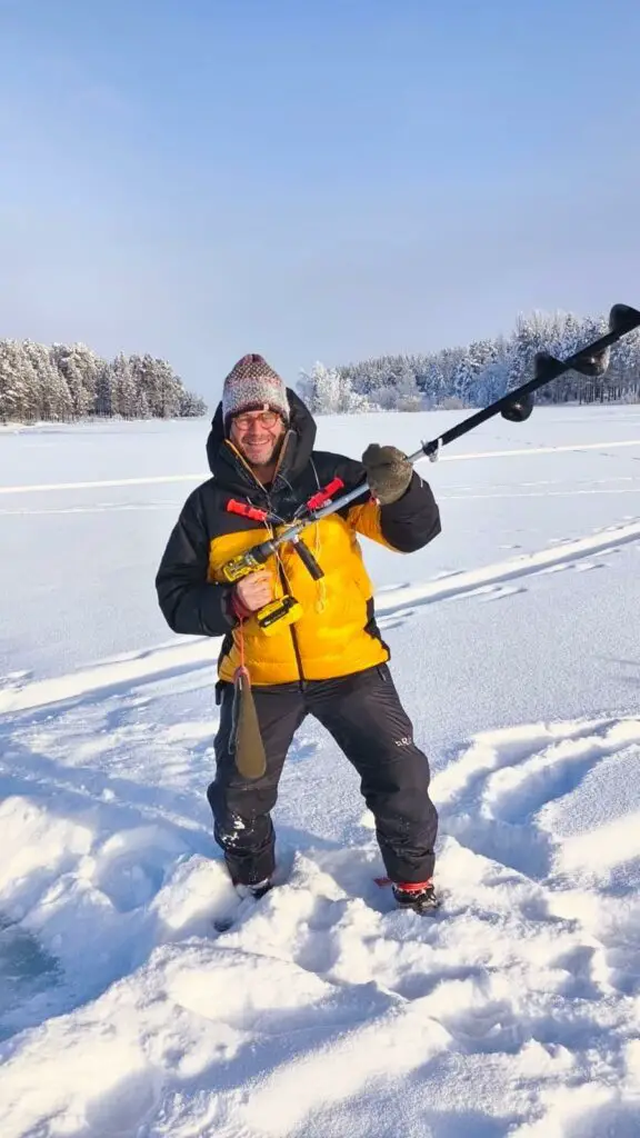 Forage dans la glace pour une session pêche blanche en laponie