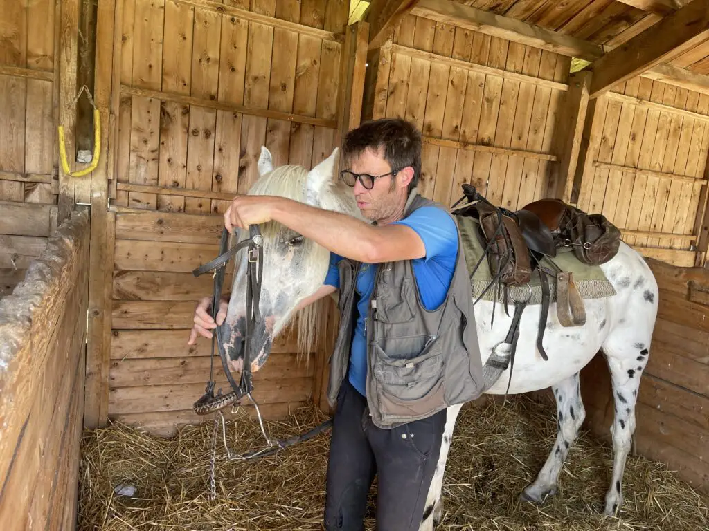 Matthieu moniteur équestre à équisud nous accompagne pour préparer notre cheval avant la randonnée