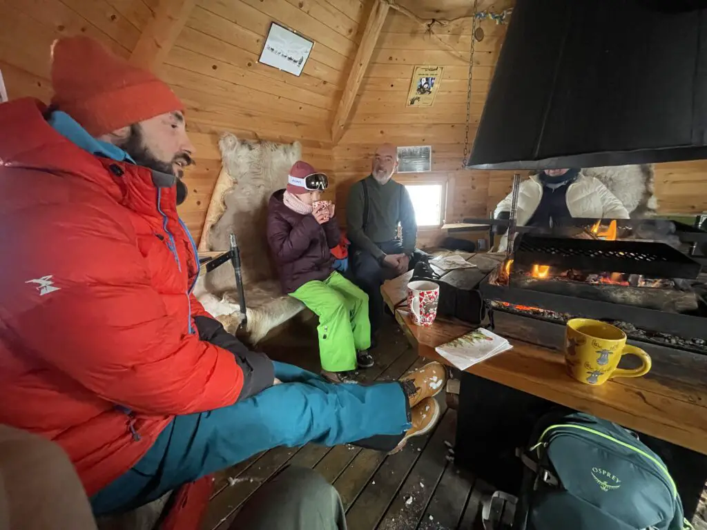Discussion et dégustation café et gateau au chocolat autour du Feu dans le Kota des mushers en laponie